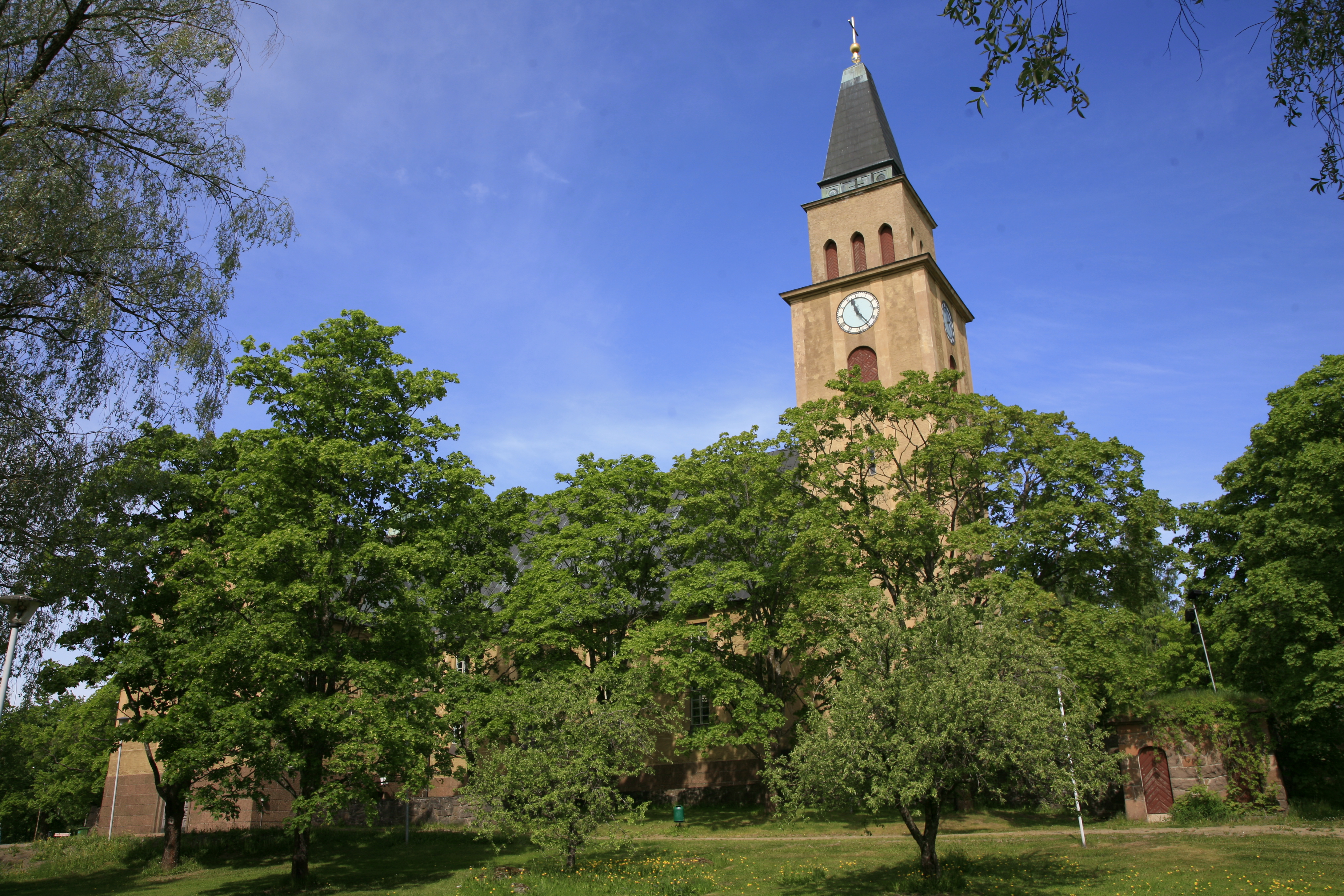Kirkko puiden takana.