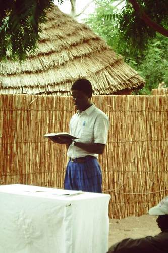 NDane Marone, Senegalin luterilaisen kirkon työntekijä seisoo ja lukee raamattua.